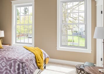 Nice tan bedroom with two windows