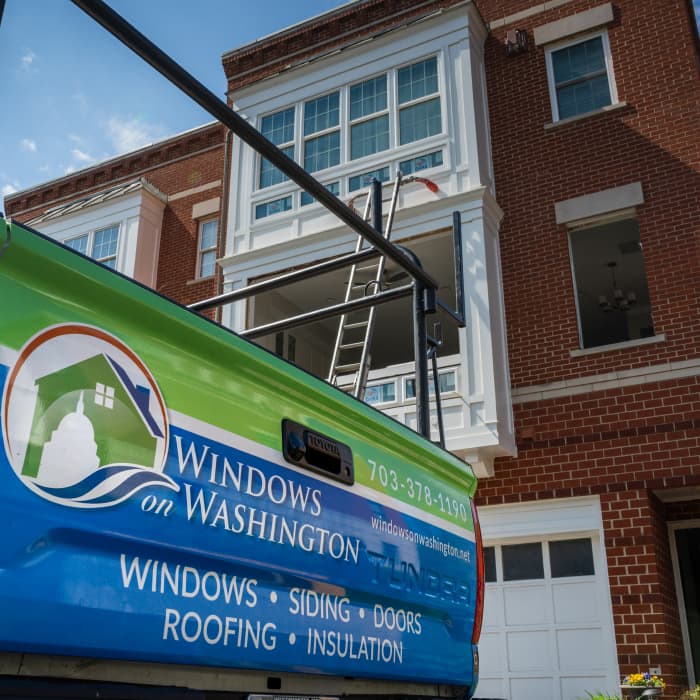 WoW truck parked in front of a stately brick building