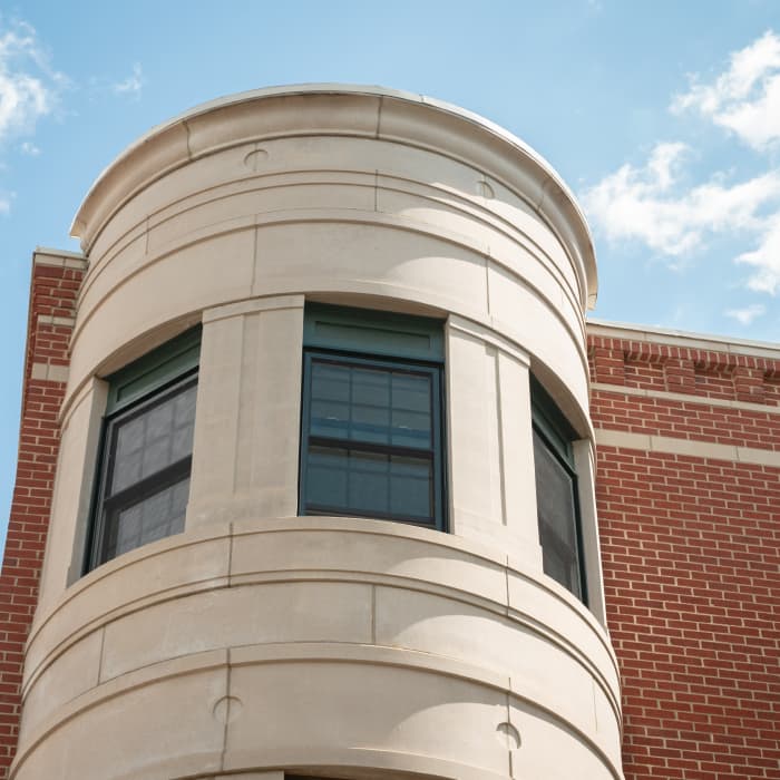 Column shaped building with three distinct windows. 