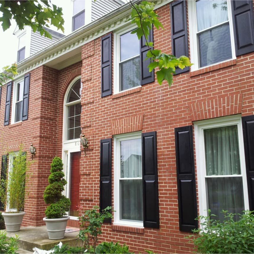 Stately brick building with inset entry and many windows