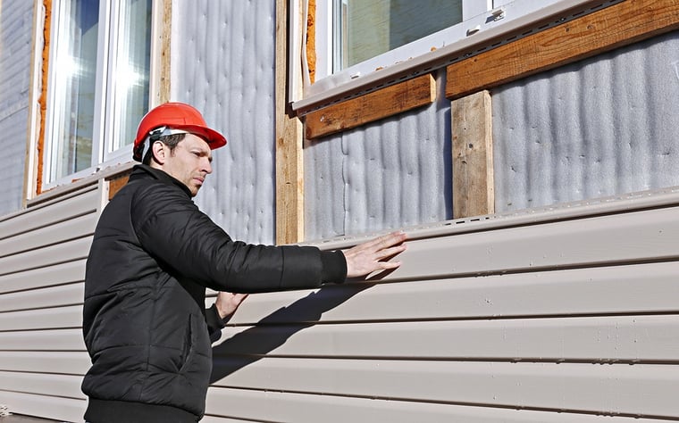 siding being fixed on home.jpg