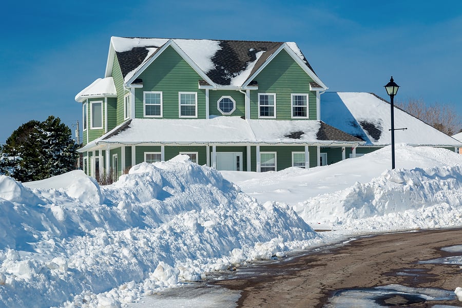 vinyl siding home in winter snow