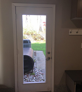 Interior shot of a glass door looking out onto a patio