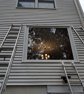 Newly-installed window with ladders on either side