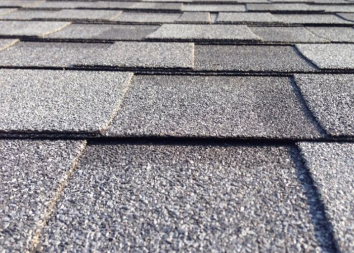 Close-up of grey asphalt roof shingles