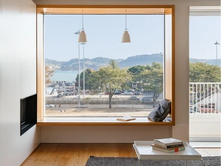 Large picture window with panoramic mountain and lake view
